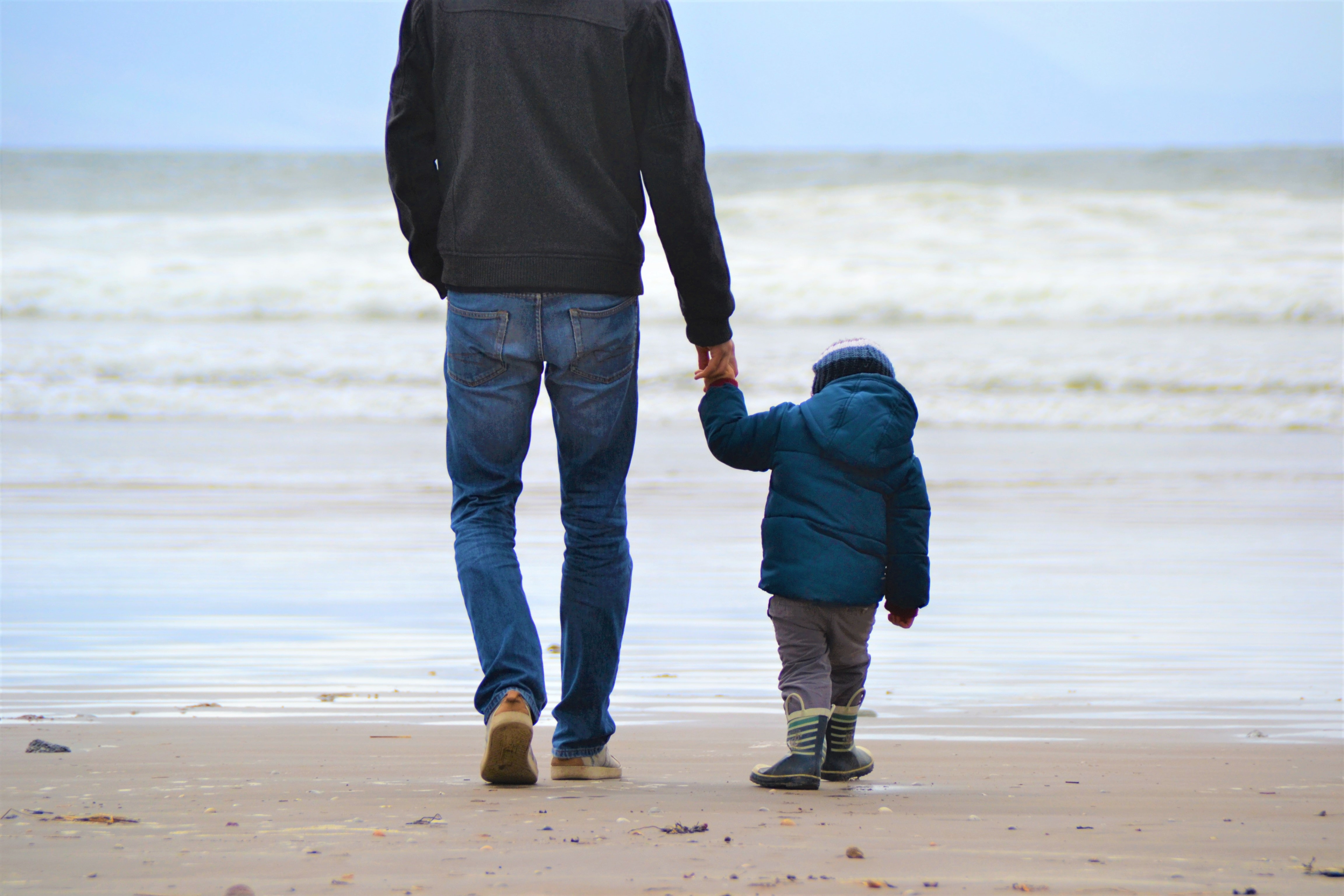 Father and son walking on beach