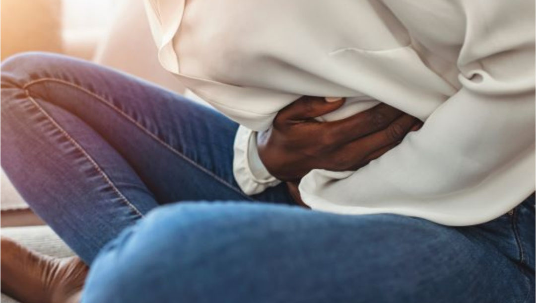 Woman holding stomach in pain