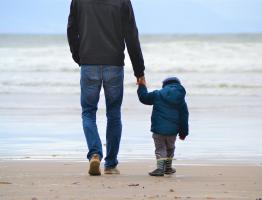 Father and son walking on beach