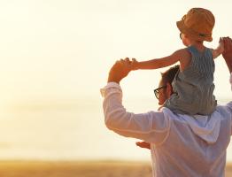 Father and son looking into sun