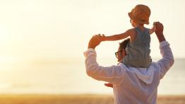 Father and son looking into sun