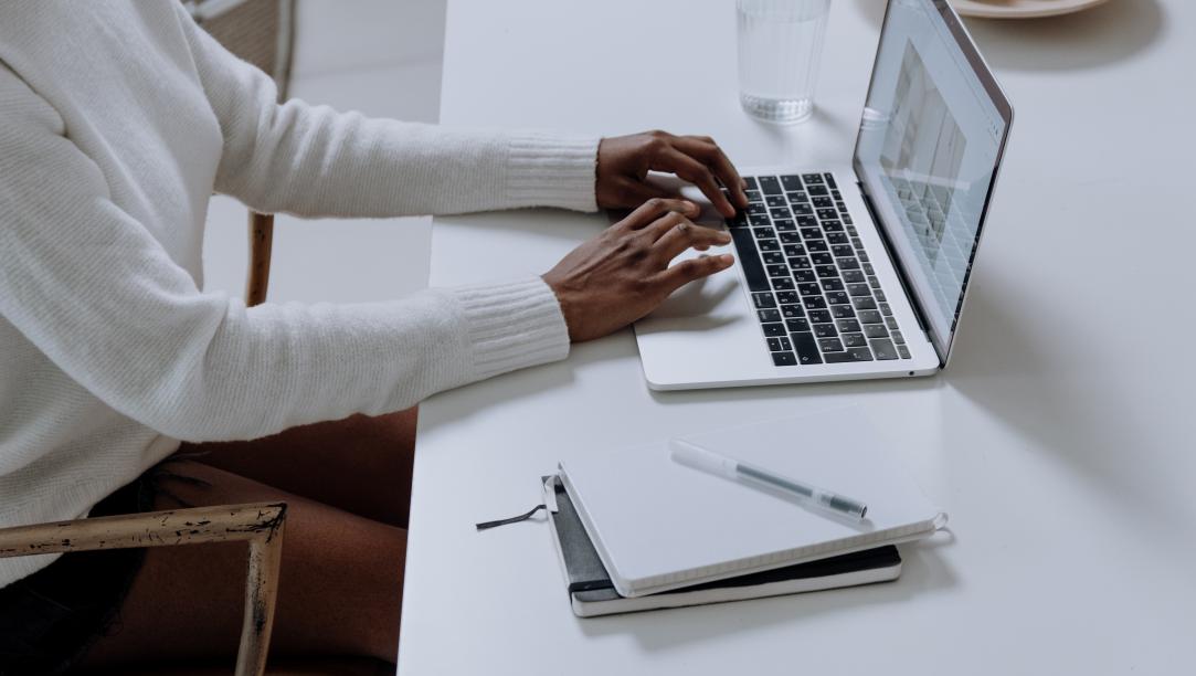 Image of person typing on a laptop